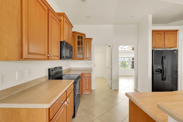 kitchen featuring black appliances and light tile patterned floors