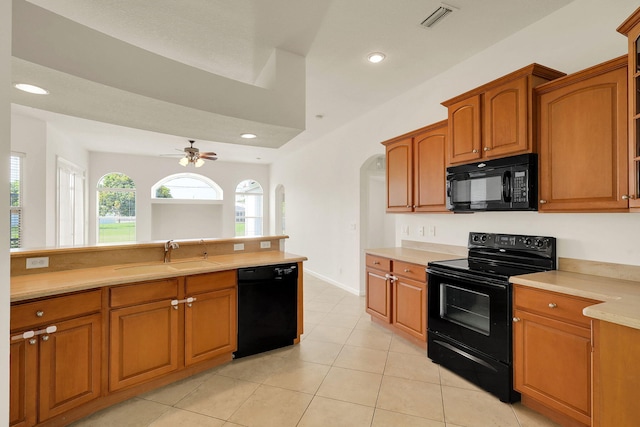 kitchen with black appliances, ceiling fan, sink, and light tile patterned floors