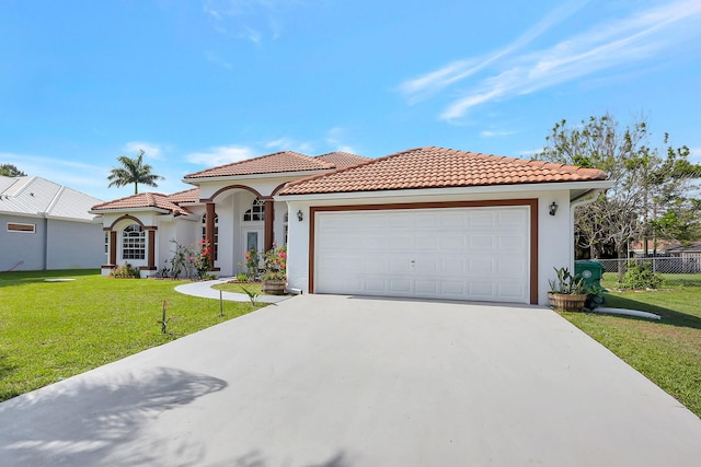 mediterranean / spanish-style house with a garage and a front yard