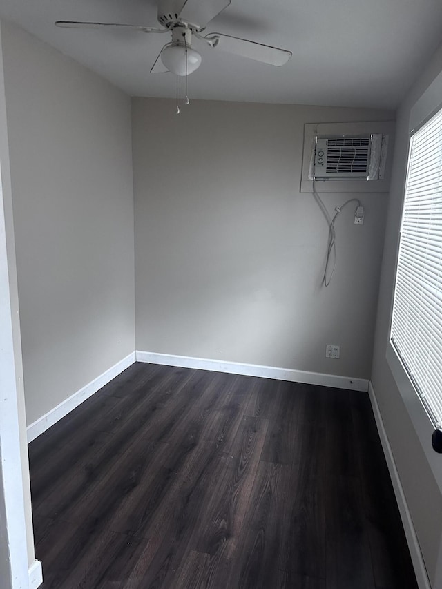 unfurnished room featuring a wall mounted AC, ceiling fan, and dark hardwood / wood-style flooring