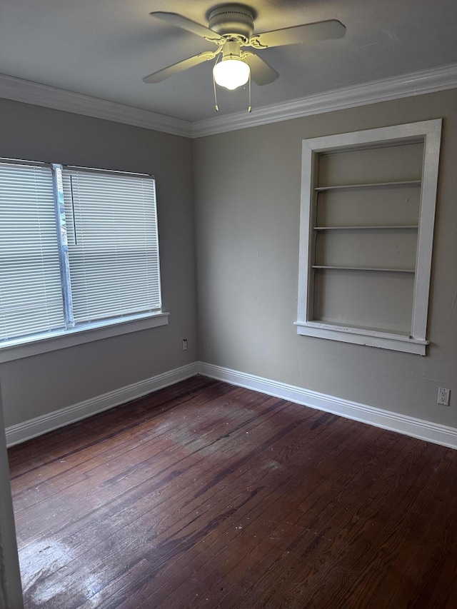 empty room with ornamental molding, dark hardwood / wood-style floors, and ceiling fan