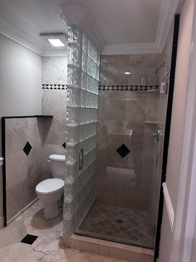 bathroom featuring toilet, crown molding, tile walls, and tiled shower