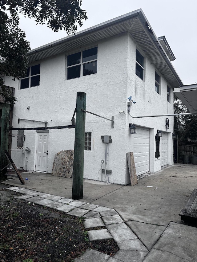 back of house featuring a garage