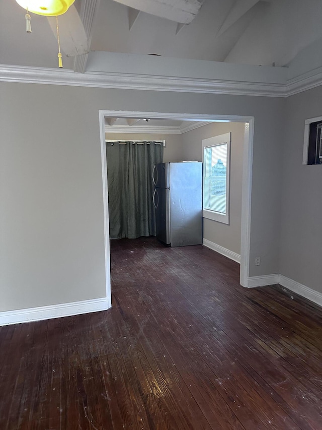 spare room with crown molding and dark hardwood / wood-style flooring