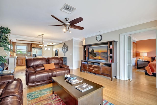 living room featuring ceiling fan, ornamental molding, and light wood-type flooring