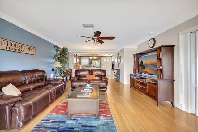 living room featuring ceiling fan, light hardwood / wood-style floors, and ornamental molding