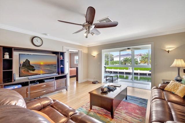 living room featuring light hardwood / wood-style flooring and ornamental molding