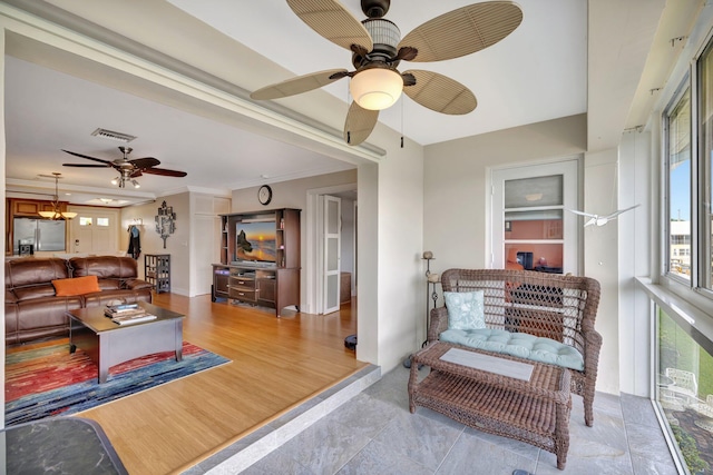 living room featuring ceiling fan, light hardwood / wood-style floors, and ornamental molding