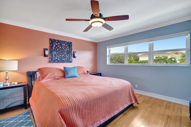 bedroom featuring ceiling fan, light hardwood / wood-style flooring, and ornamental molding