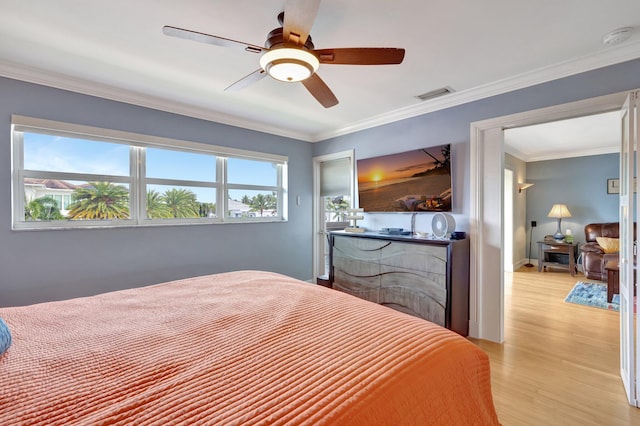 bedroom with ceiling fan, light hardwood / wood-style floors, crown molding, and multiple windows