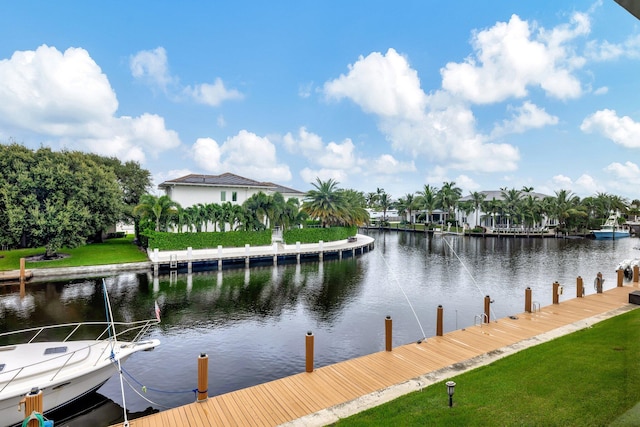 dock area featuring a lawn and a water view