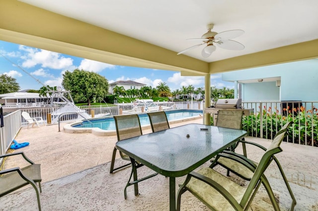 view of patio / terrace with ceiling fan, area for grilling, and a fenced in pool