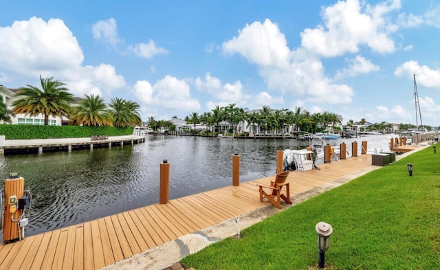 dock area featuring a lawn and a water view