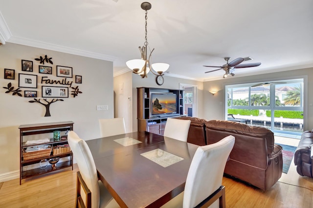 dining area featuring ceiling fan with notable chandelier, crown molding, and light hardwood / wood-style flooring