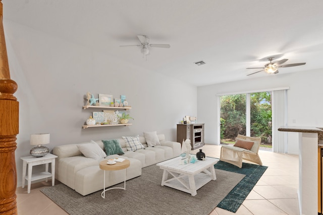 living area featuring light tile patterned floors, visible vents, and a ceiling fan