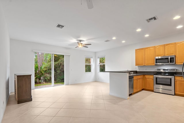 kitchen featuring dark countertops, appliances with stainless steel finishes, a ceiling fan, and recessed lighting