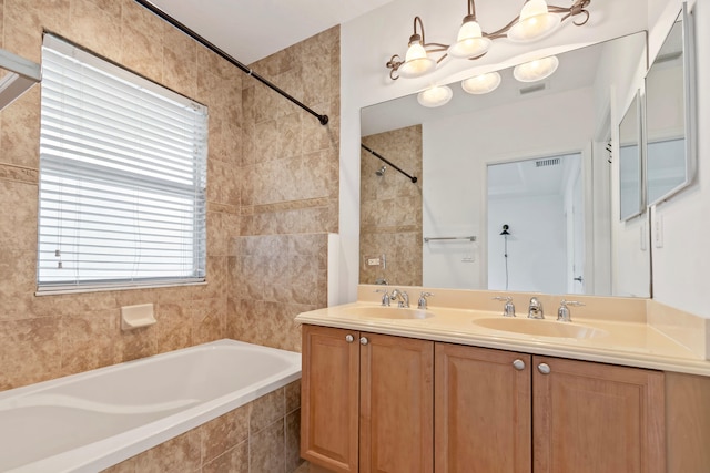 bathroom with visible vents, a chandelier, double vanity, and a sink