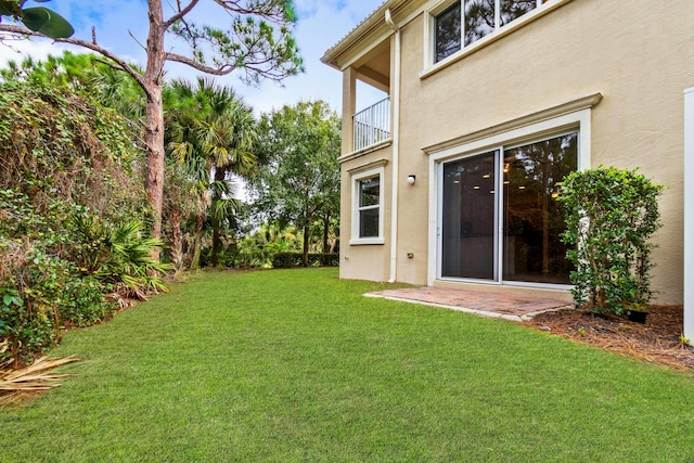 view of yard featuring a balcony and a patio