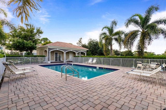pool featuring fence and a patio