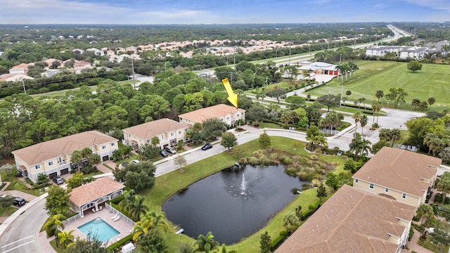 drone / aerial view with a water view and a residential view