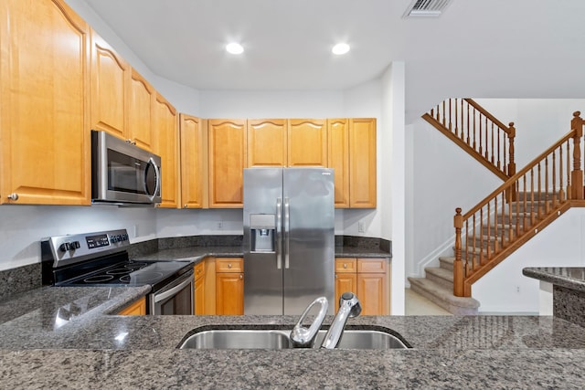 kitchen featuring dark stone countertops, a sink, visible vents, appliances with stainless steel finishes, and recessed lighting