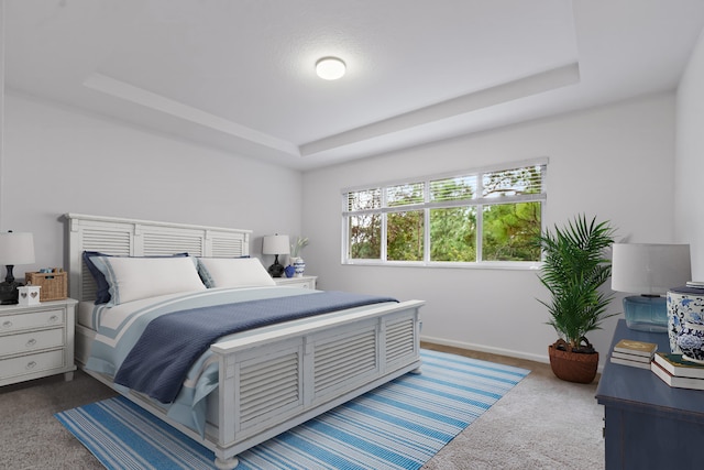 carpeted bedroom featuring a tray ceiling and baseboards