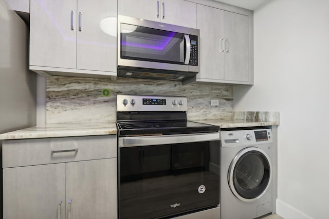 kitchen with stainless steel appliances, washer / clothes dryer, and decorative backsplash