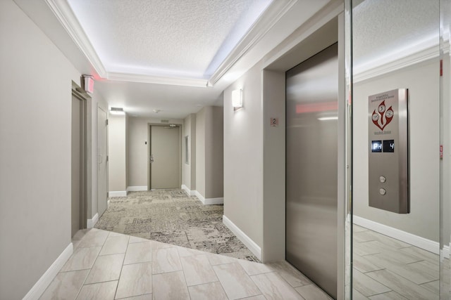 hallway featuring elevator, ornamental molding, light carpet, and a textured ceiling