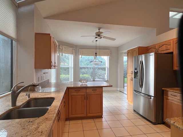 kitchen with light tile patterned floors, sink, ceiling fan, decorative light fixtures, and stainless steel fridge with ice dispenser