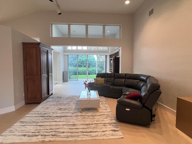 living room with high vaulted ceiling and track lighting