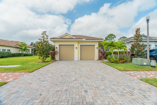 view of front facade with a garage and a front yard