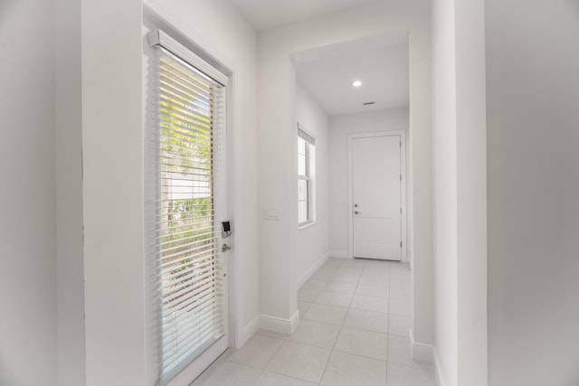 doorway to outside featuring light tile patterned floors