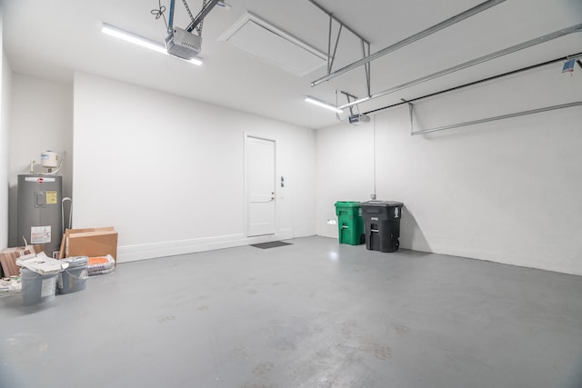 garage with electric water heater and a garage door opener