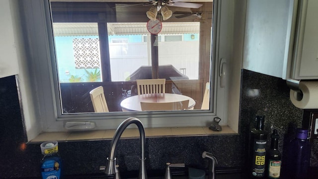 interior space featuring ceiling fan and sink