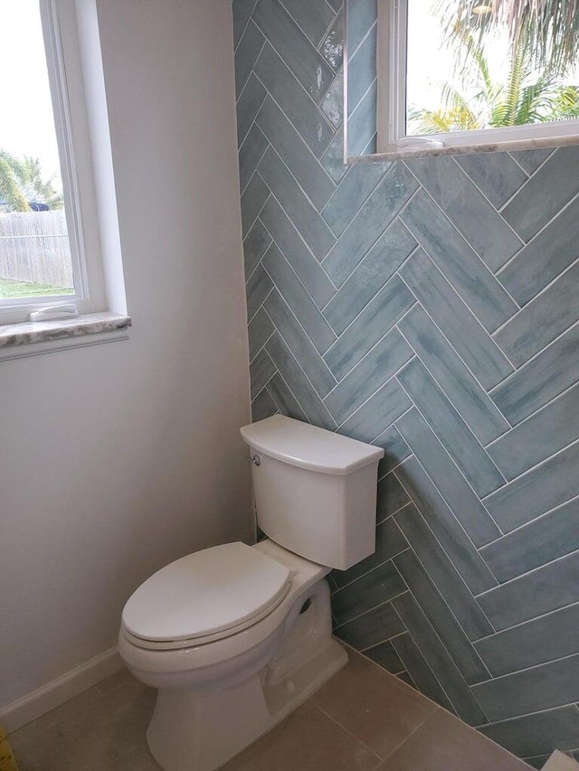 bathroom with toilet and a wealth of natural light