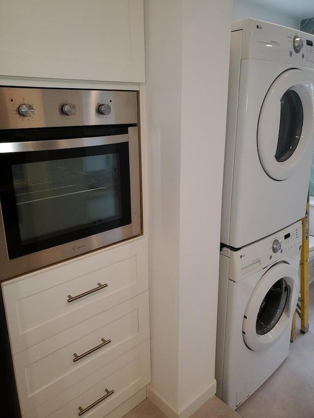 laundry area with stacked washer and clothes dryer