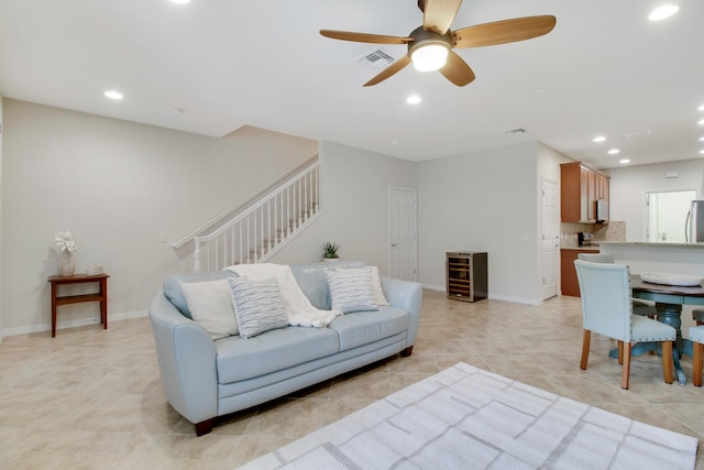 living room featuring ceiling fan and light tile patterned floors