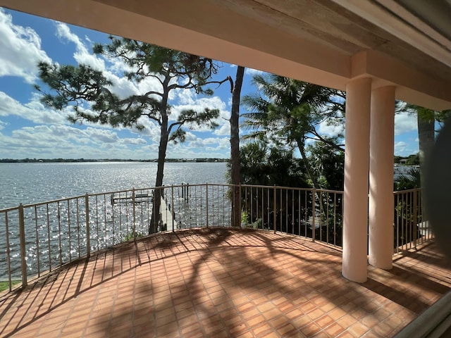 wooden terrace featuring a water view