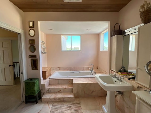 bathroom with sink, a relaxing tiled tub, and wooden ceiling