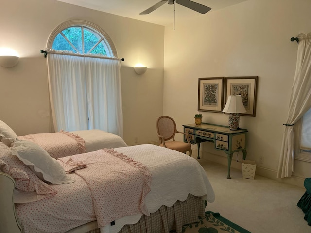 bedroom featuring ceiling fan and carpet