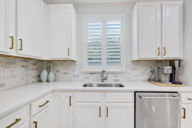 kitchen featuring sink, dishwasher, white cabinetry, and backsplash