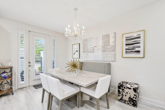 dining space featuring a chandelier and light hardwood / wood-style floors