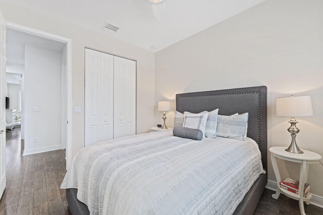 bedroom featuring dark hardwood / wood-style floors, a closet, and ceiling fan