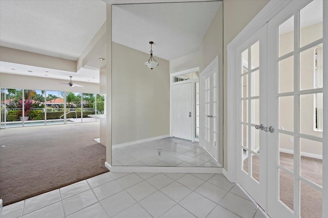 bathroom featuring french doors, ceiling fan, tile patterned floors, and a textured ceiling