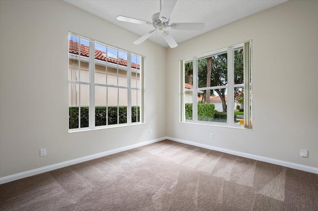 spare room featuring ceiling fan, a textured ceiling, and carpet flooring