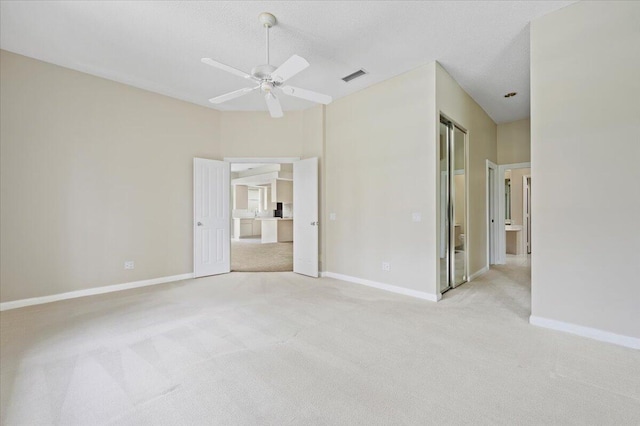 unfurnished bedroom with baseboards, carpet flooring, ceiling fan, and visible vents