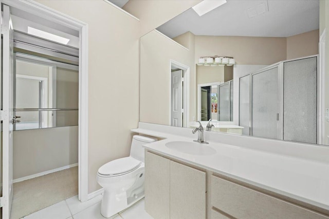 bathroom with vanity, toilet, tile patterned floors, and a shower with door