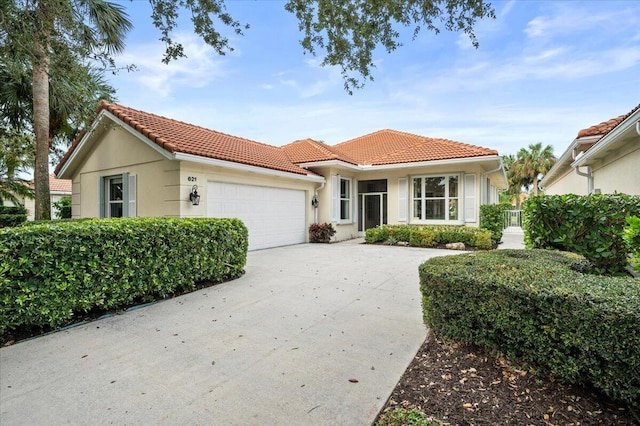 mediterranean / spanish-style house with a garage