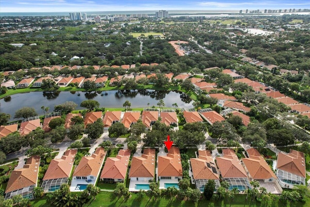 drone / aerial view featuring a residential view, a city view, and a water view