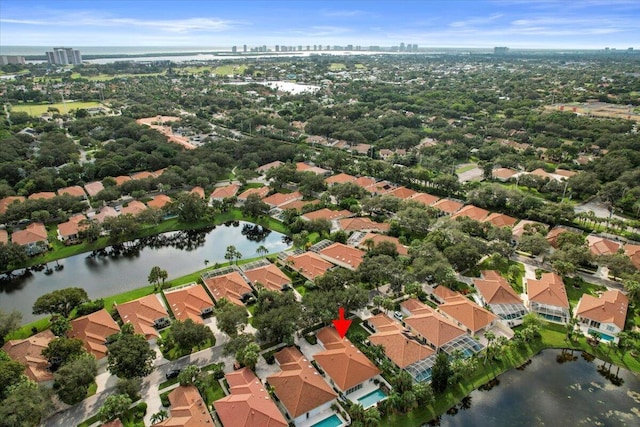drone / aerial view with a residential view, a view of city, and a water view